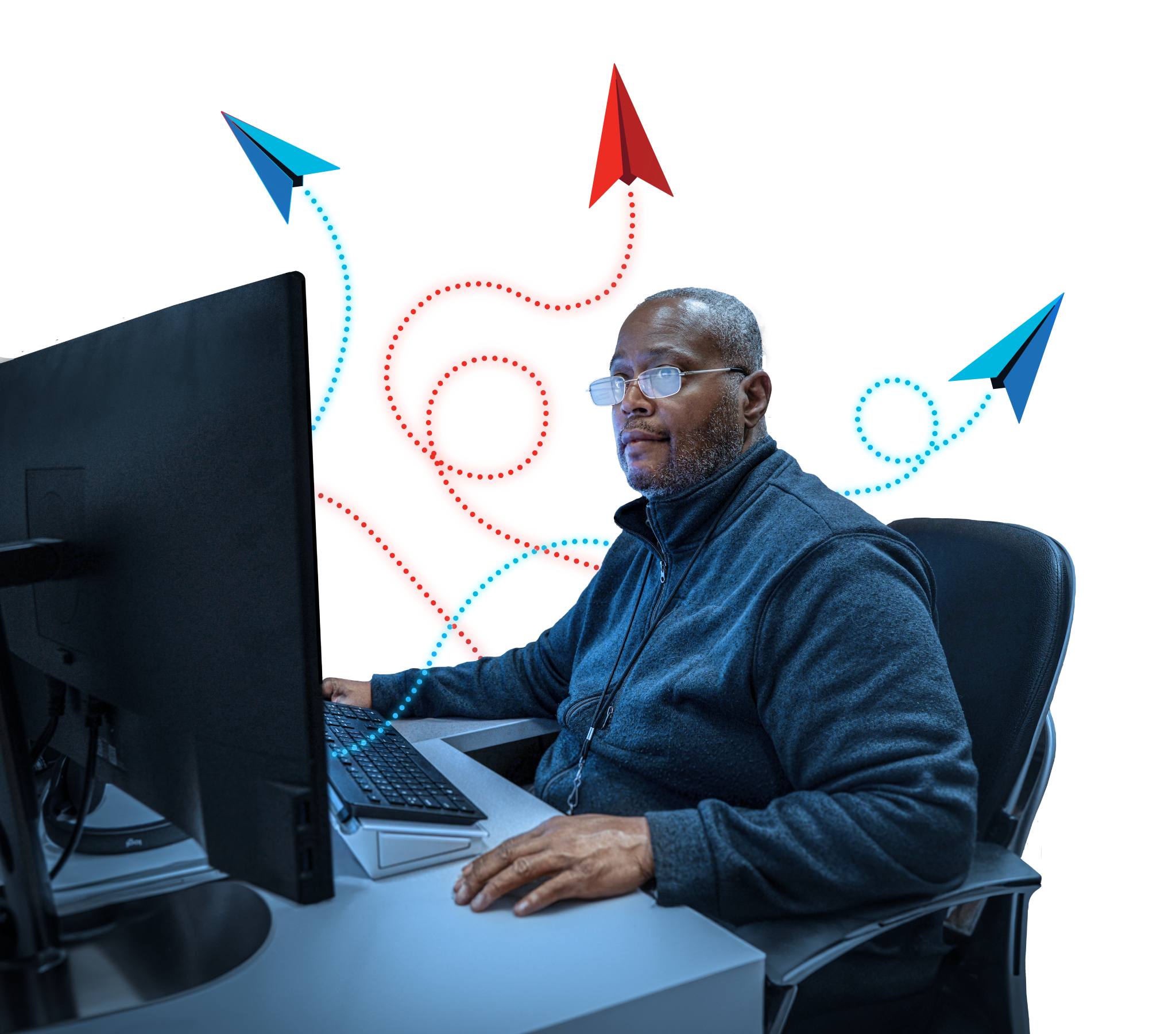 Man sitting in front of his computer at his desk with airplane icons representing the Software Factory floating above him